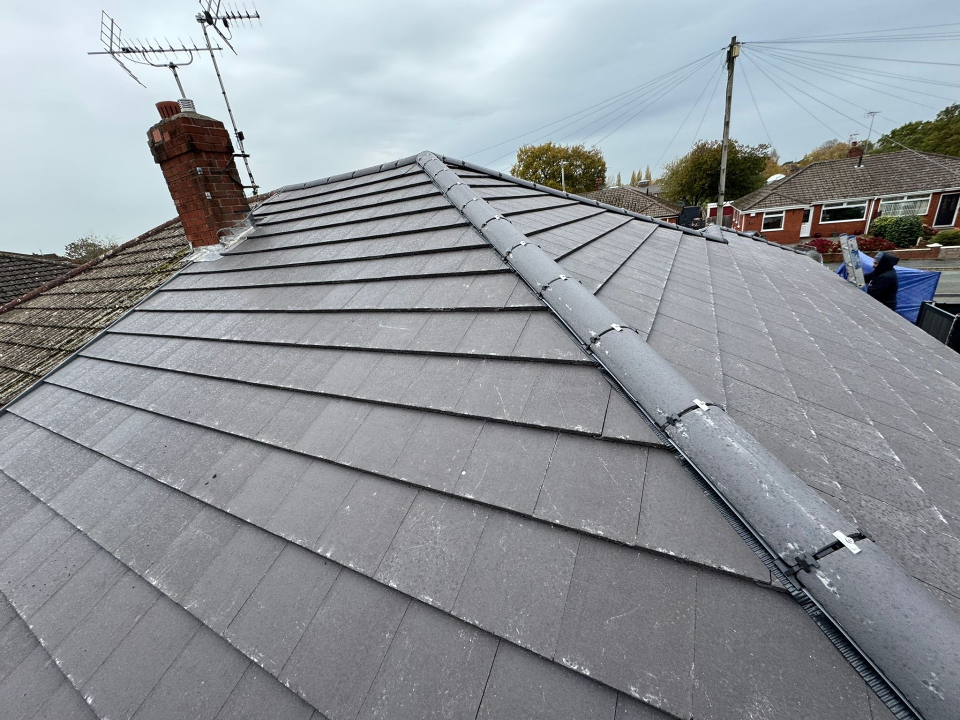 Completed new interlocking roof tiles with hip ridge detail