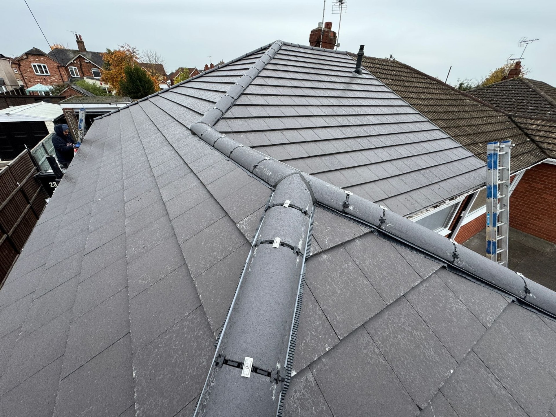 New slate roof ridge tiles with mechanical fixings on a completed Keystone re-roof