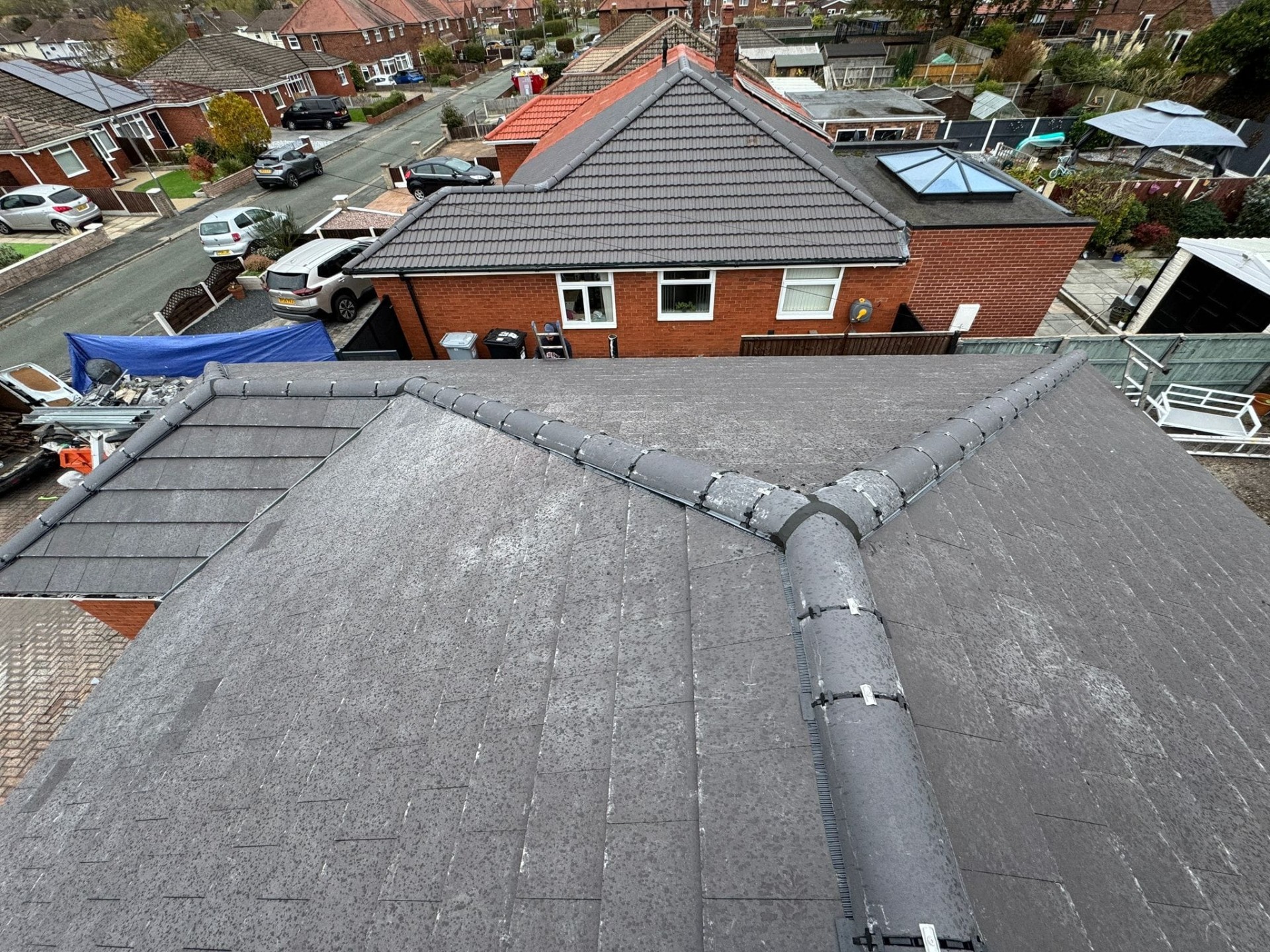 Completed roof repair with new ridge tiles on a residential property