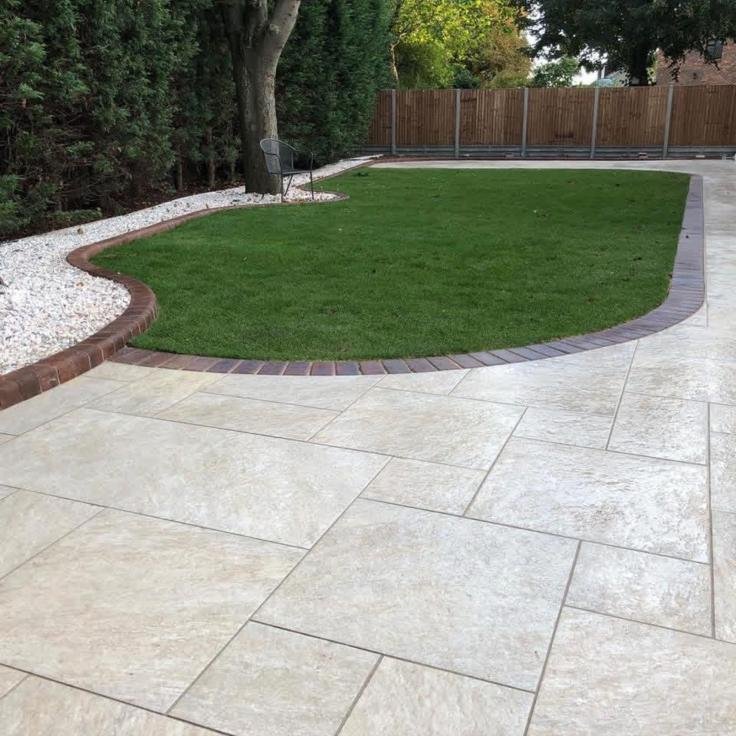 Porcelain patio with curved brick edge and new lawn in a Hereford garden